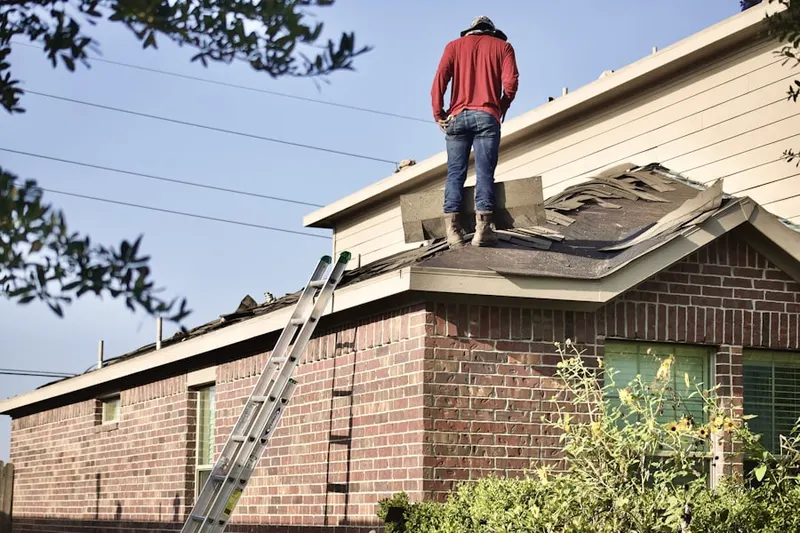 Professional roofer working on a residential roof in Terre Grande